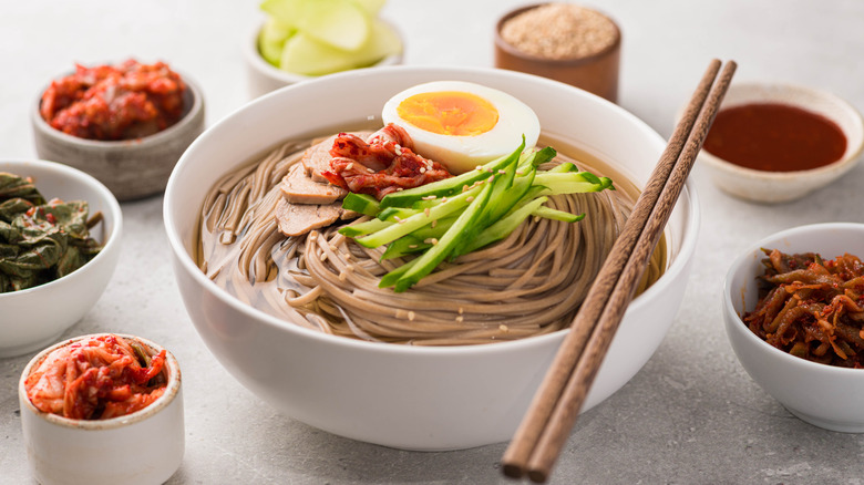A bowl of naengmyeon with banchan