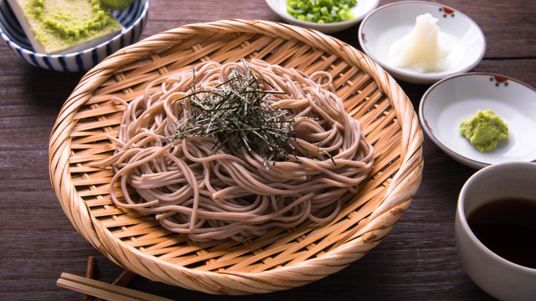 A plate of zaru soba noodles with condiments