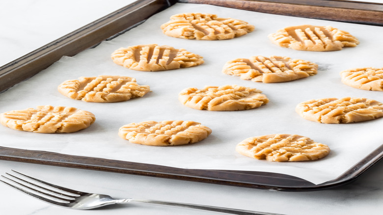 cookie sheet with parchment paper and raw cookies
