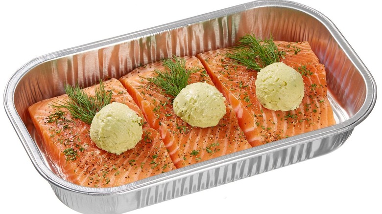 Container of salmon with pesto butter