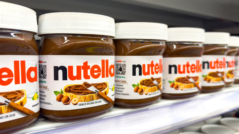 Nutella jars lined up in a row in grocery store