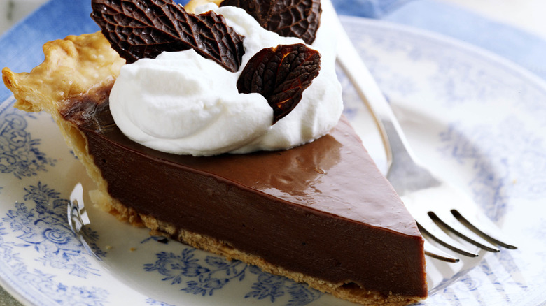 A chocolate cream pie decorated with chocolate leaves