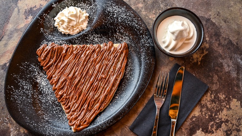 Nutella crepe on black plate