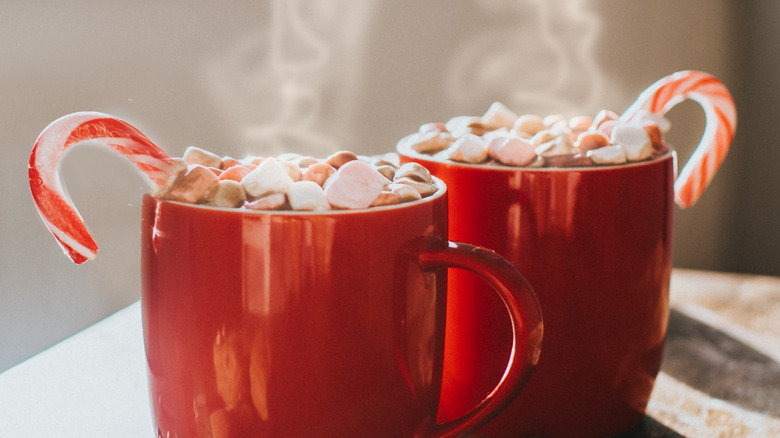 Two mugs of steaming hot chocolate