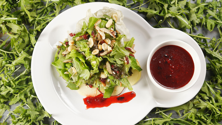 Salad with side of cranberry dressing