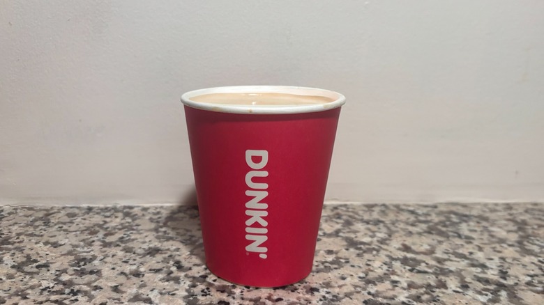 Small Dunkin'Nutty Pumpkin Protein Latte on a granite counter top