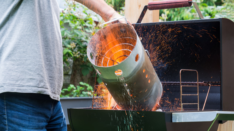 man using a charcoal chimney