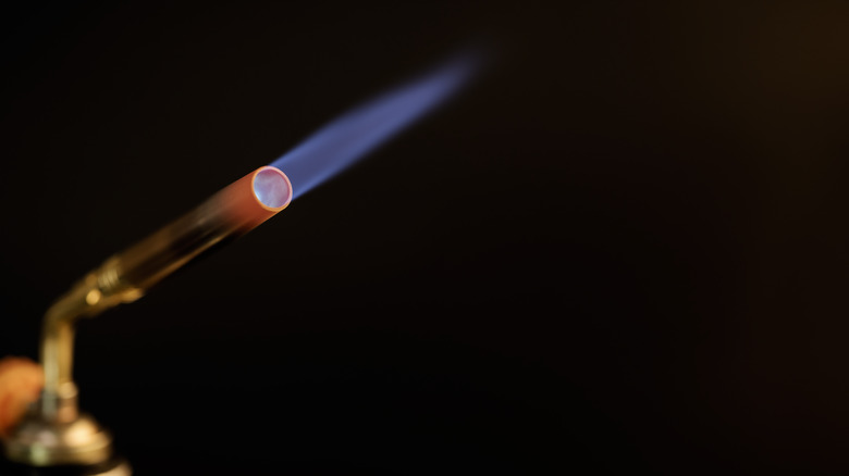 lit torch with black background