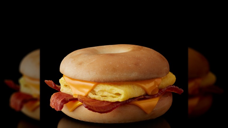 A McDonald's bacon, egg, and cheese bagel on a black background
