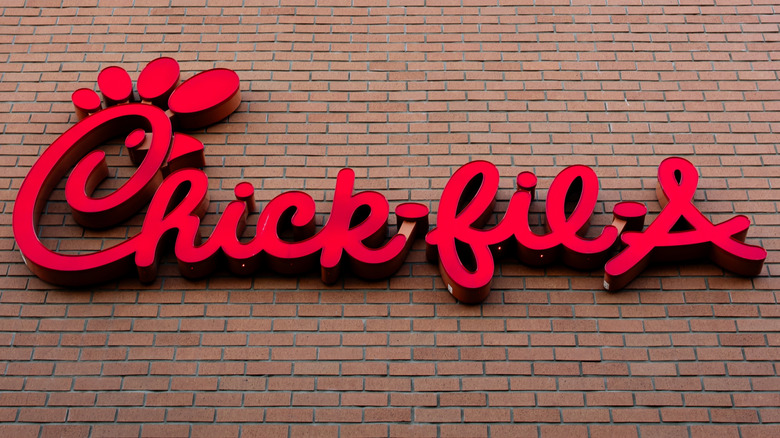 The red sign on the brick exterior of a Chick-fil-A restaurant