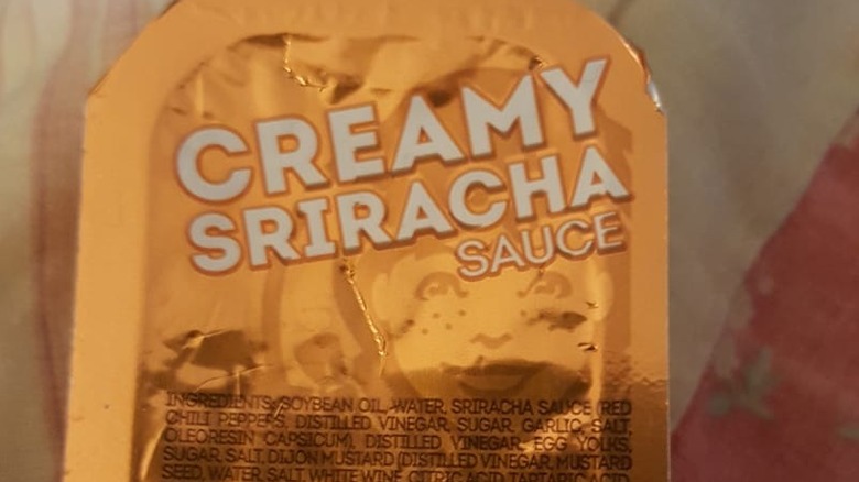 A close-up of a packet of Wendy's Creamy Sriracha sauce