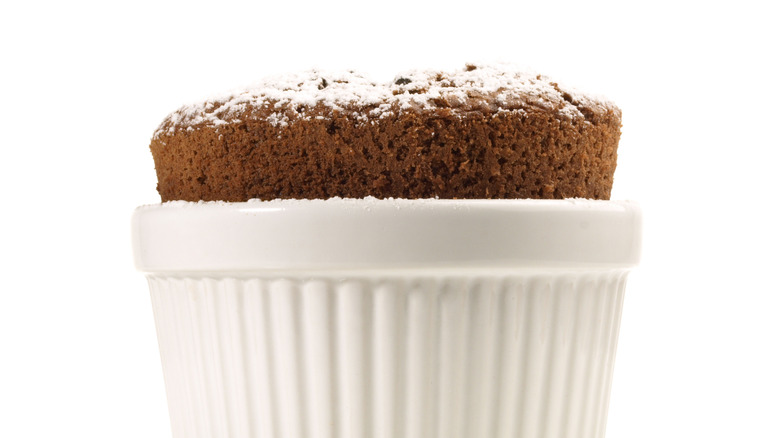 chocolate souffle in white ramekin on white background