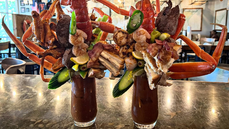 Two Bloody Mary's stacked with meat and seafood at The Blind Pelican