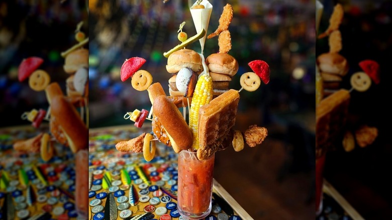 A Bloody Mary at Smashed on the Rocks topped with sliders, tater tots, and corn