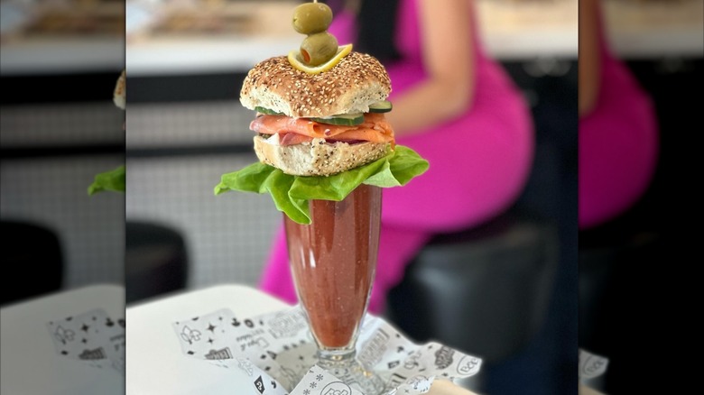 The Lox'd & Loaded Bloody Mary at Buffalo & Bergen topped with a lox bagel and stuffed olives