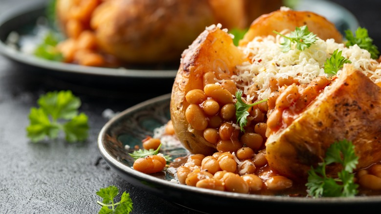 A filled jacket potato with beans and cheese on plate