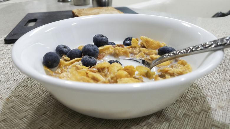 A bowl of cereal and milk in an office