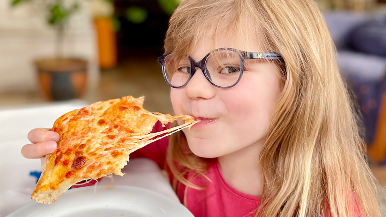 Girl eating cheese pizza