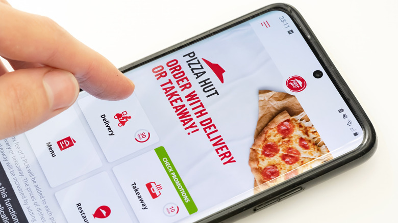 Person ordering pizza on Pizza Hut app