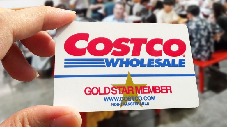 A close up of someone holding a Costco Gold Star membership card