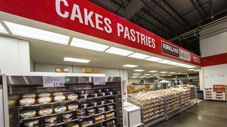 A Costco bakery with shelves of cakes and pastries
