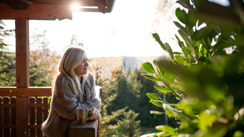 woman enjoying garden view from porch