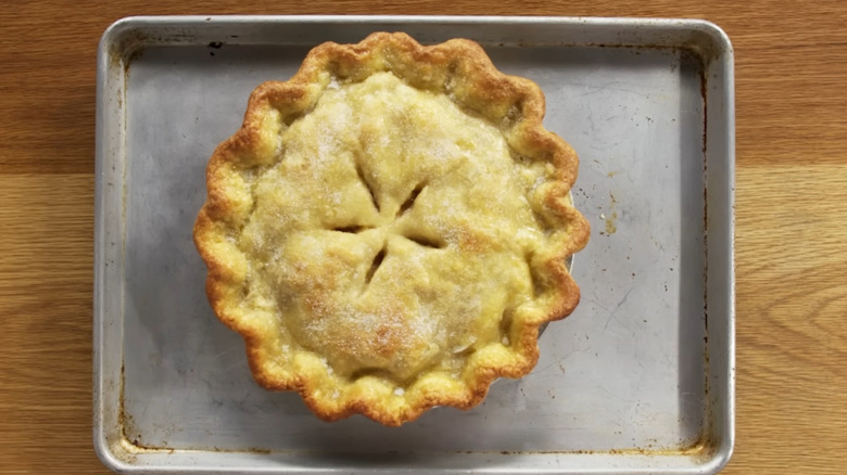 Top view of a baked pie with vents cut into it