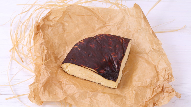 A wedge of dry Jack cheese on a piece of parchment paper.