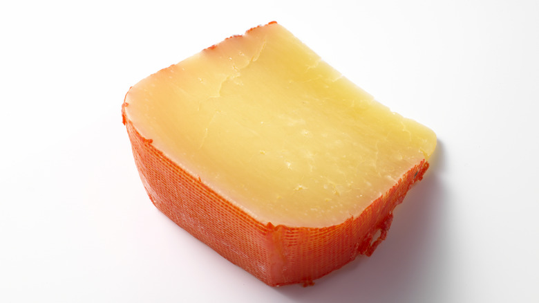 A wedge of aged Mahón cheese.