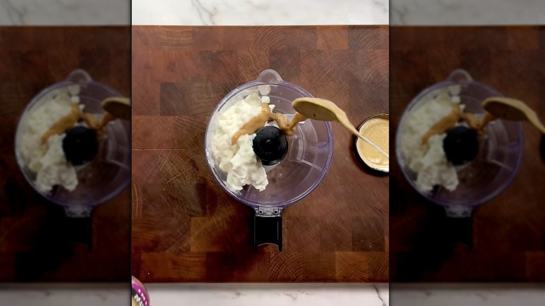 Pouring tahini into cottage cheese