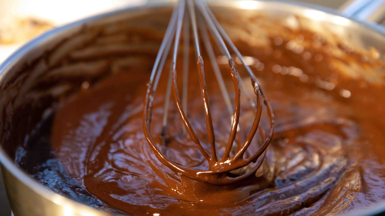 Chocolate cake mix in a bowl with a whisk