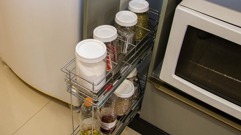 Spice jars on a rack next to a stove