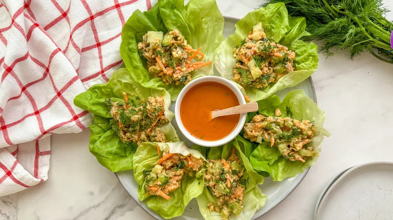 six Buffalo Chickpea Lettuce Wraps surrounding a ramekin of Buffalo sauce