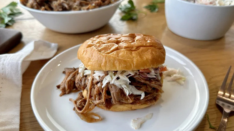 Easy Slow Cooker Pulled Pork with cole slaw on a bun