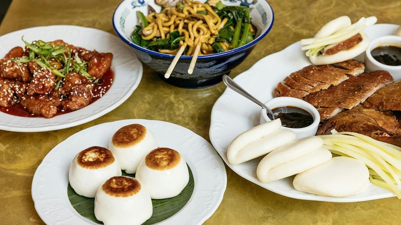 Plates of Chinese food laid out on a table at Brewery Bhavana