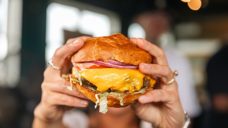 A burger from Briar Commons held in two hands