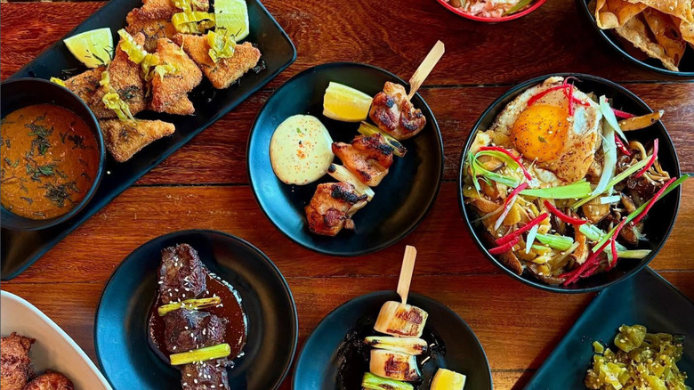 Several Japanese plates from The Send, including skewers and noodle bowls