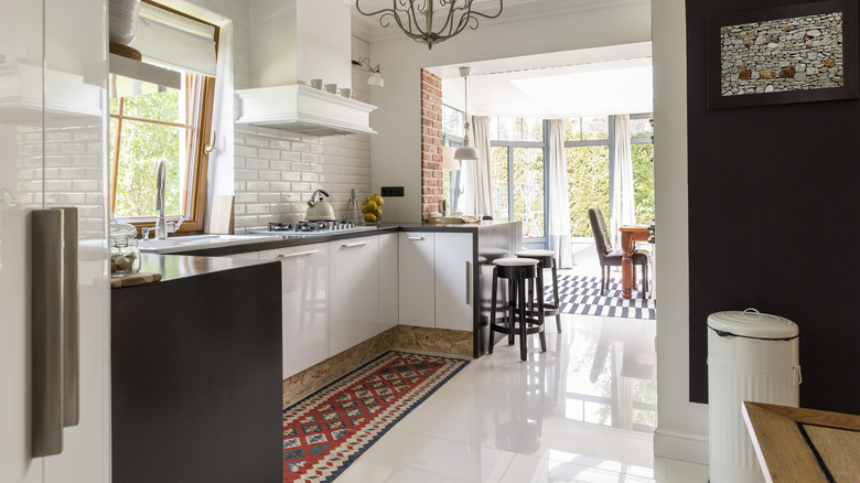 White kitchen with colorful runner rug