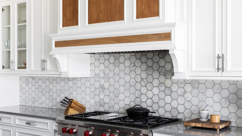 Kitchen with a wooden accented hood range