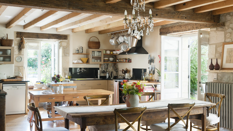 A country kitchen with overhead beams and wooden accents