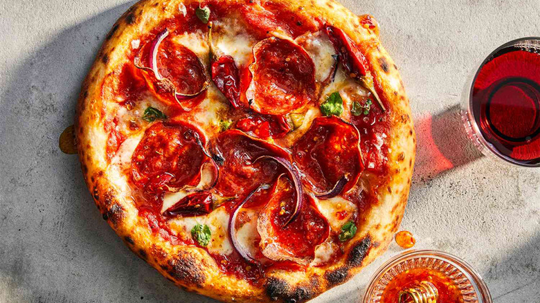 Pizza with meat and a hot honey drizzle