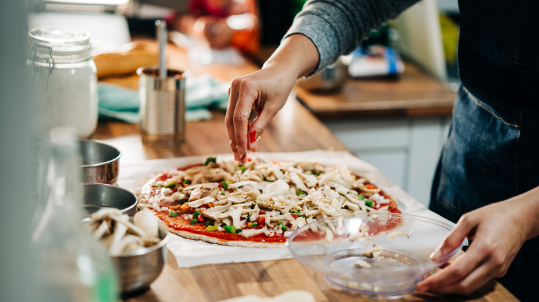 Person making pizza at home