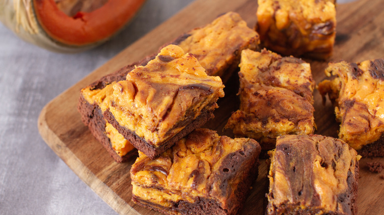 Pumpkin brownie slices on a wooden board