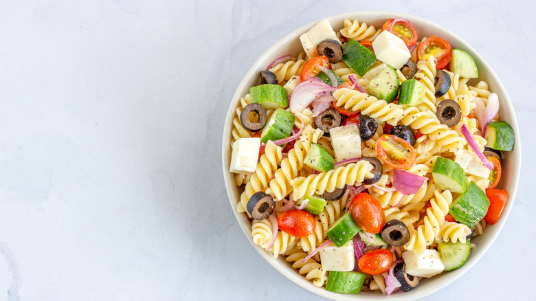 Pasta salad with feta, olives, and sliced veggies