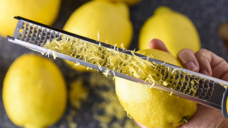 Person zesting a lemon