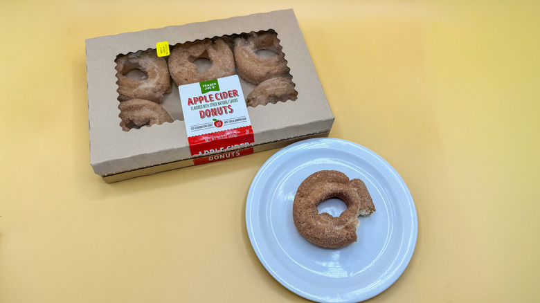 Box of Apple Cider Donuts next to a plate with one donut on it