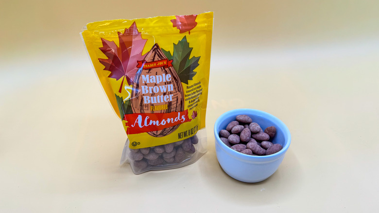 Package of Maple Brown Butter Flavored Almonds beside nuts in a bowl