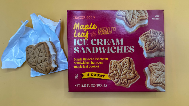 Bite taken out of individual Maple Leaf Ice Cream Sandwich beside its packaging