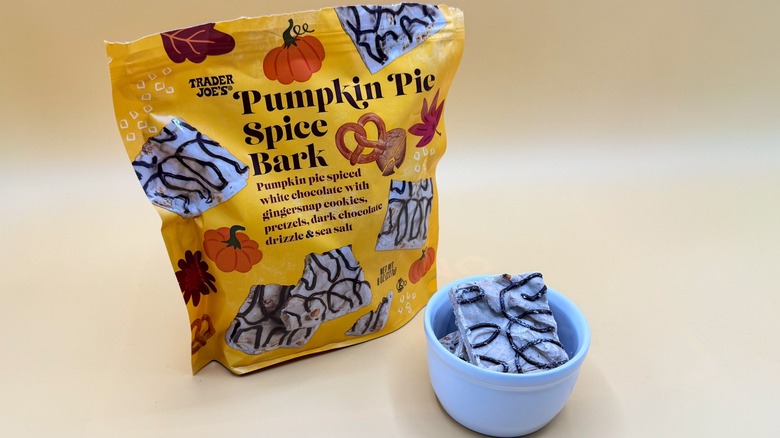 Bag of Pumpkin Pie Spice Bark next to a filled bowl on yellow surface