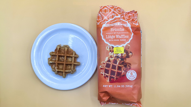 Pumpkin & Spice Brioche-Style Liège Waffle on a plate next to its packaging